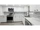 Modern kitchen featuring stainless steel appliances and white shaker cabinets at 11592 110Th Ter, Seminole, FL 33778