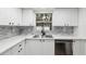Modern kitchen with white cabinets, stainless steel appliances, and stylish backsplash at 11592 110Th Ter, Seminole, FL 33778
