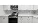 Stainless steel appliances and white cabinetry in this updated kitchen at 11592 110Th Ter, Seminole, FL 33778