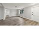 Spacious living room featuring gray walls, wood-look flooring, and neutral decor at 11592 110Th Ter, Seminole, FL 33778