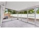 Spacious screened patio with gray tile flooring at 11592 110Th Ter, Seminole, FL 33778