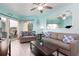 Beach-themed living room featuring a sofa, coffee table, and balcony access at 12000 Gulf Blvd # 303N, Treasure Island, FL 33706