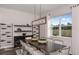 Elegant dining room with dark wood table, wine storage, and modern light fixture at 12652 Glenn Creek Dr, Riverview, FL 33569