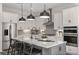 Modern kitchen with white cabinets, a large island, and stainless steel appliances at 12652 Glenn Creek Dr, Riverview, FL 33569