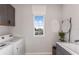 Bright laundry room with washer, dryer, and modern cabinets at 12652 Glenn Creek Dr, Riverview, FL 33569