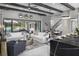 Bright living room with a view of the pool, exposed beam ceiling and elegant decor at 14638 Swiss Bridge Dr, Lithia, FL 33547