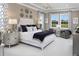 Serene main bedroom featuring tray ceilings, neutral tones, and ample natural light at 14638 Swiss Bridge Dr, Lithia, FL 33547