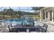 Gorgeous screened-in pool with water features, an outdoor dining area, and a view of the lake at 14638 Swiss Bridge Dr, Lithia, FL 33547
