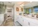 Bathroom featuring double vanity, walk-in shower, and view of a closet at 14814 Paddock Pond Ave, Lithia, FL 33547