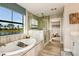 Spa-like bathroom with large window, garden tub, and walk-in shower at 14814 Paddock Pond Ave, Lithia, FL 33547