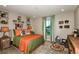 Rustic-themed bedroom with orange bedding and wood accents at 14814 Paddock Pond Ave, Lithia, FL 33547