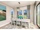 Bright dining room with light-grey table and chairs, and a lake view at 14814 Paddock Pond Ave, Lithia, FL 33547
