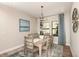 Elegant dining room with a large chandelier and neutral decor at 14814 Paddock Pond Ave, Lithia, FL 33547