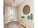 Inviting entryway with a unique clock and decorative console table at 14814 Paddock Pond Ave, Lithia, FL 33547