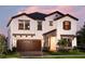Two-story house with brown accents and a large wooden garage door at 14814 Paddock Pond Ave, Lithia, FL 33547