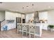 Modern white kitchen with island, stainless steel appliances, and white cabinets at 14814 Paddock Pond Ave, Lithia, FL 33547