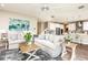 Living room with comfortable sofas and a view into the kitchen area at 14814 Paddock Pond Ave, Lithia, FL 33547