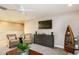 Bright living room with a TV, comfortable seating, and stylish decor at 14814 Paddock Pond Ave, Lithia, FL 33547