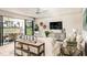 Living room with sliding doors leading to patio and water view at 14814 Paddock Pond Ave, Lithia, FL 33547