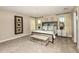Spacious main bedroom with king-size bed, nightstands, and window views at 14814 Paddock Pond Ave, Lithia, FL 33547