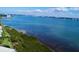 Aerial view of waterfront property with boaters and city skyline in the distance at 1501 Gulf Blvd # 104, Clearwater Beach, FL 33767