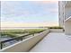 Spacious balcony overlooking water view at sunset at 1501 Gulf Blvd # 104, Clearwater Beach, FL 33767