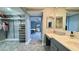 Main bathroom with vanity, large mirror and bedroom view at 1501 Gulf Blvd # 104, Clearwater Beach, FL 33767