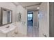 Guest bathroom with pedestal sink and view of the bedroom at 1501 Gulf Blvd # 104, Clearwater Beach, FL 33767