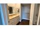 Updated bathroom with pedestal sink, new flooring, and modern vanity at 1501 Gulf Blvd # 104, Clearwater Beach, FL 33767