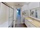Bathroom with tub, shower and updated vanity at 1501 Gulf Blvd # 104, Clearwater Beach, FL 33767