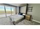Bedroom with murphy bed and sliding doors leading to a balcony at 1501 Gulf Blvd # 104, Clearwater Beach, FL 33767
