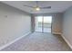 Spacious bedroom with balcony access and ceiling fan at 1501 Gulf Blvd # 104, Clearwater Beach, FL 33767