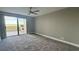 Bright bedroom with balcony access and ceiling fan at 1501 Gulf Blvd # 104, Clearwater Beach, FL 33767