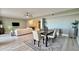 Modern dining area with light wood table and neutral decor at 1501 Gulf Blvd # 104, Clearwater Beach, FL 33767
