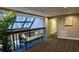 Bright hallway with seating area and natural light from skylight at 1501 Gulf Blvd # 104, Clearwater Beach, FL 33767