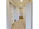 Hallway with built-in shelving and closets, leading to other rooms at 1501 Gulf Blvd # 104, Clearwater Beach, FL 33767