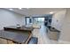 Modern kitchen with a view of the living room and balcony at 1501 Gulf Blvd # 104, Clearwater Beach, FL 33767