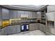 Modern kitchen with stainless steel appliances and granite countertops at 1501 Gulf Blvd # 104, Clearwater Beach, FL 33767