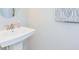 Small bathroom with pedestal sink and updated fixtures at 1621 Eagle Creek Dr, Clearwater, FL 33764