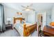 Bedroom with wood bed frame, ceiling fan, and adjacent bath at 1621 Eagle Creek Dr, Clearwater, FL 33764