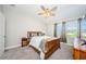 Bright bedroom with wood frame bed and window at 1621 Eagle Creek Dr, Clearwater, FL 33764