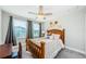 Bright bedroom with wood bed frame and ceiling fan at 1621 Eagle Creek Dr, Clearwater, FL 33764