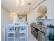 Dining area with white table and gray chairs, view of kitchen at 1621 Eagle Creek Dr, Clearwater, FL 33764