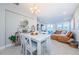 Light and airy dining area with white table and brown leather couch at 1621 Eagle Creek Dr, Clearwater, FL 33764