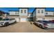 Two-story townhome with white garage doors and light gray siding at 1621 Eagle Creek Dr, Clearwater, FL 33764