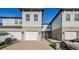 Front view of a townhome with a light gray exterior and white garage door at 1621 Eagle Creek Dr, Clearwater, FL 33764