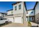 Townhome with light gray siding, white garage door, and a walkway at 1621 Eagle Creek Dr, Clearwater, FL 33764