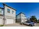 Townhome with light gray siding, white garage doors, and landscaping at 1621 Eagle Creek Dr, Clearwater, FL 33764