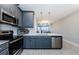Modern kitchen with gray cabinets, stainless steel appliances, and island at 1621 Eagle Creek Dr, Clearwater, FL 33764