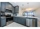 Stainless steel appliances and gray cabinets in this modern kitchen at 1621 Eagle Creek Dr, Clearwater, FL 33764